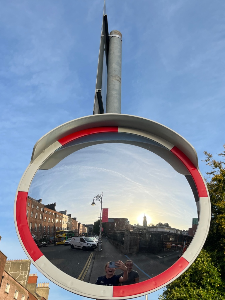 A mirror selfie with a traffic mirror